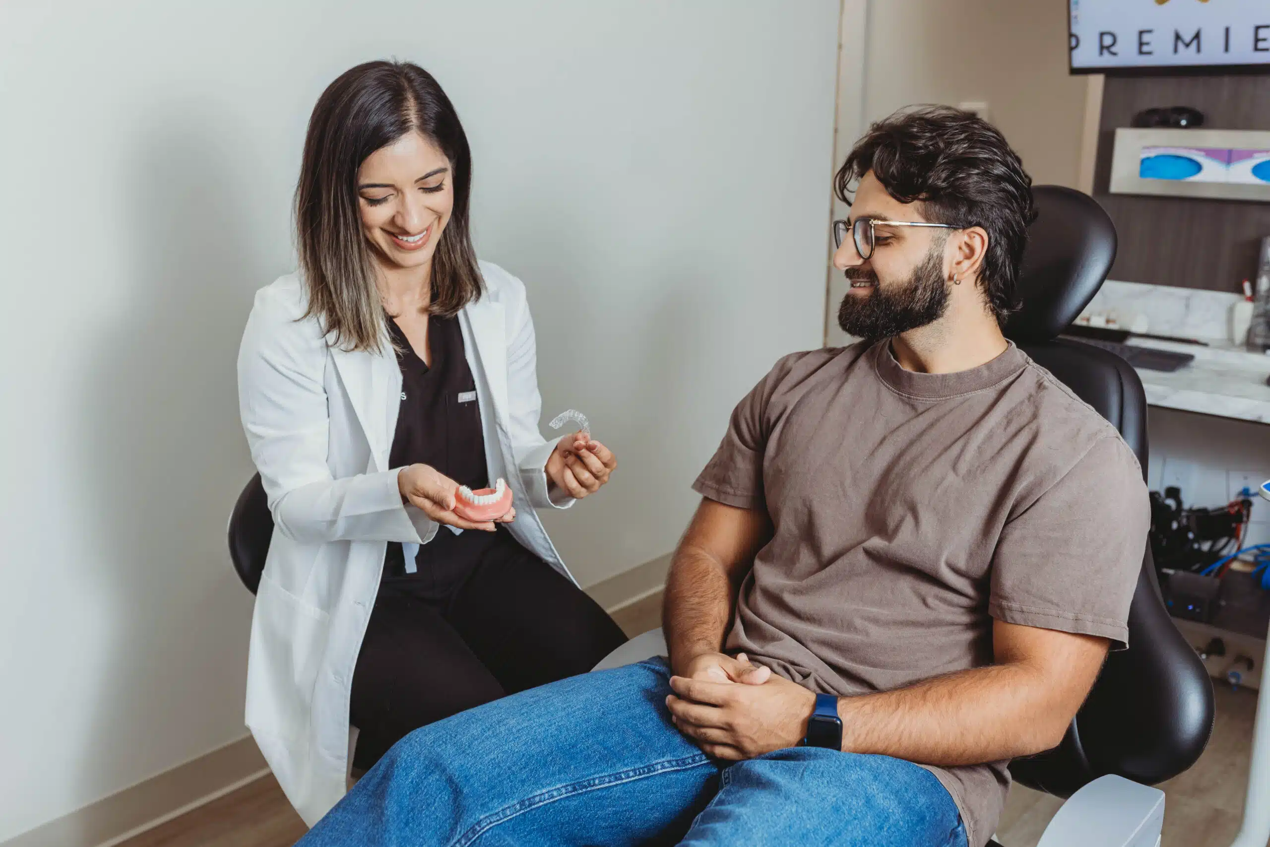 Dentist explaining Invisalign treatment to an adult patient