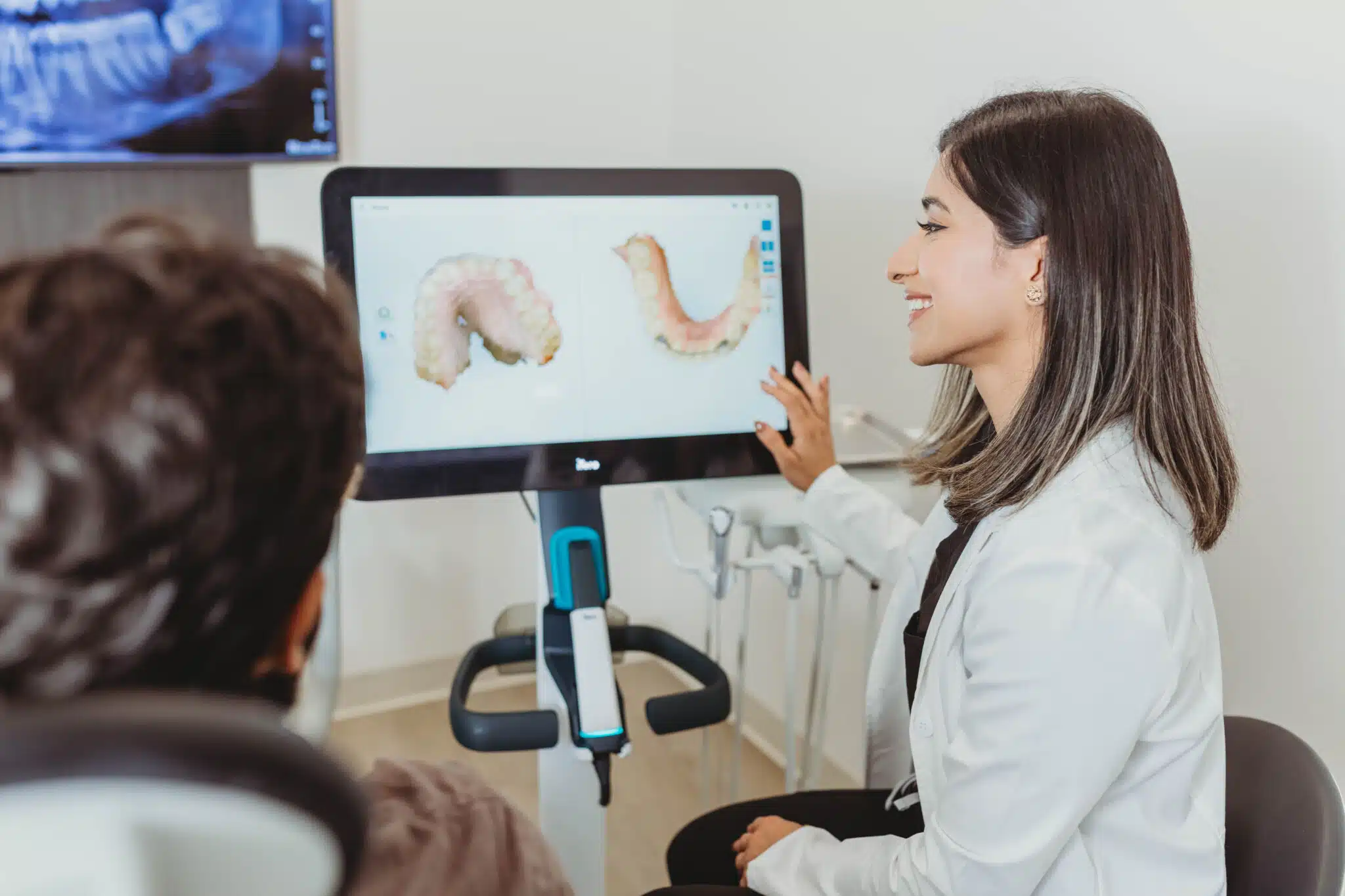 Dentist reviewing a digital smile design with a patient